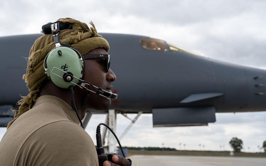 U.S. Air Force Senior Airman Jarrett Scott, 7th Aircraft Maintenance Squadron crew chief, discusses a hot-pit refuel plan with U.S. B-1B Lancer pilots via headset at Mihail Kogălniceanu Air Base, Romania, June 12, 2023.