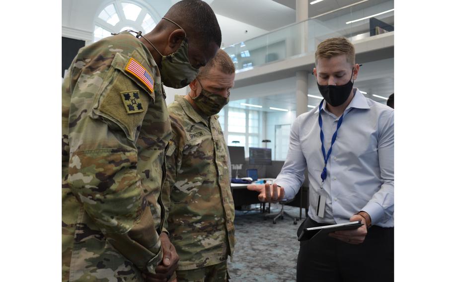 Capt. Dan Lyell, product manager at the Army Software Factory in Austin, Texas, discusses the This is My Squad app with Sgt. Maj. of the Army Michael Grinston, center, and Command Sgt. Maj. Michael Crosby, left, senior enlisted advisor for Army Futures Command, on Oct. 28, 2021. The app is named for Grinston’s signature program and aims to improve time management for troops.