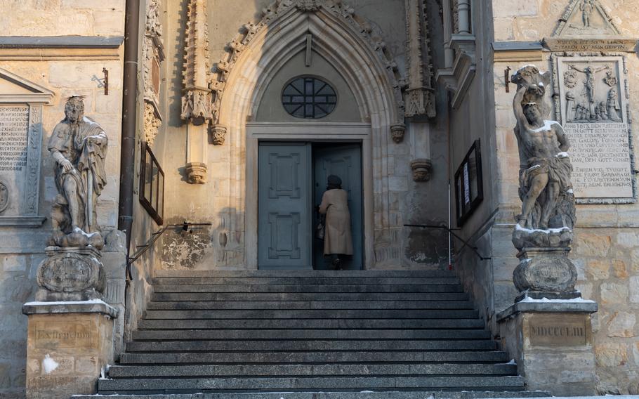 An elderly woman enters the Church of the Assumption of the Blessed Virgin Mary in Boleslawiec, Poland, on Dec. 14, 2022. Some older town residents were against the arrival of U.S. forces in 2017, but support for the Americans has become almost unanimous following Russia’s invasion of Ukraine this year. 