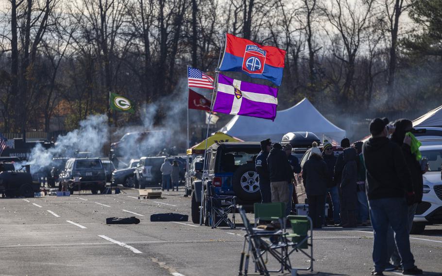 Tailgaters with flags before the game.