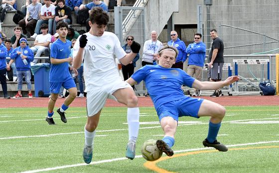 Ramstein defender Jayden Andrews tackles the ball of SHAPE's Santiago Torrente de la Pisa during a match on April 5, 2024, at Ramstein High School on Ramstein Air Base, Germany.