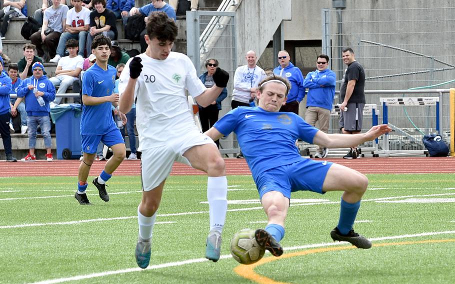 Ramstein defender Jayden Andrews tackles the ball of SHAPE's Santiago Torrente de la Pisa during a match on April 5, 2024, at Ramstein High School on Ramstein Air Base, Germany.