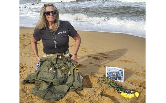 This photo provided by Jeanie Jacobs Huffman shows her on the beach in June 2024, two miles away from where her father's plane and crew were discovered in 70 feet of water, in Thanh Hoa Province, Vietnam. (Dave Huffman/Jeanie Jacobs Huffman via AP)