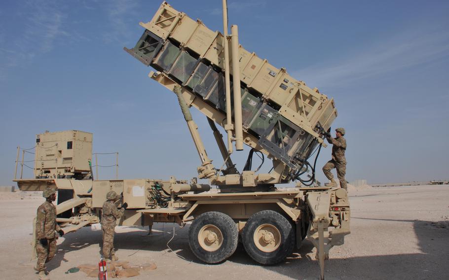 Sgt. Charles Glover, Pfc. Michael Schultz and Pfc. James Weaver, from left, of the 62nd Air Defense Artillery Regiment, prepare a Patriot missile to fire during an exercise at Al Udeid Air Base, Qatar, in 2015. A former U.S. Central Command boss and analysts say it is likely that the U.S. will reduce the number of troops it keeps in the Middle East.
 
