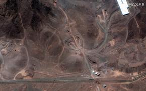 A satellite image of a barren surface with stretches of road or tunnel snaking across it.
