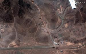 A satellite image of a barren surface with stretches of road or tunnel snaking across it.
