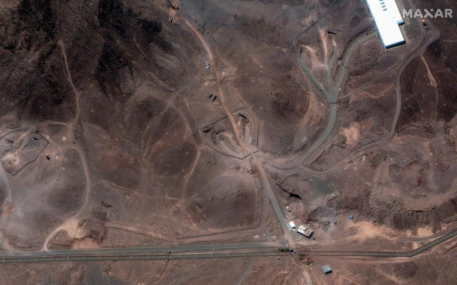 A satellite image of a barren surface with stretches of road or tunnel snaking across it.