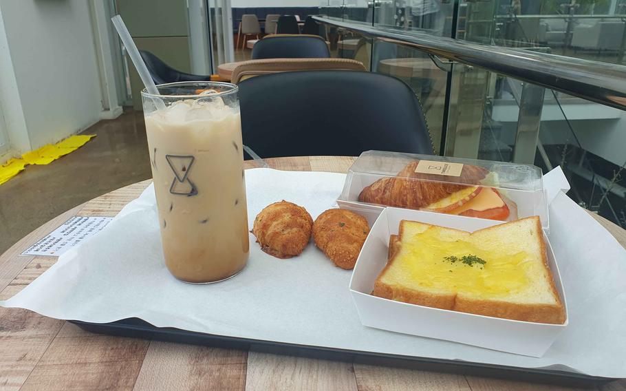 A caramel macchiato, croissants, grilled cheese sandwich and croissant sandwich at Timeslice Cafe & Bakery in Pyeongtaek, South Korea, on July 18, 2023. 