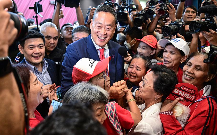 Srettha Thavisin, center, approved by Thai lawmakers to become the kingdom's 30th prime minister, is hugged by supporters at the party headquarters after the parliament's prime ministerial vote in Bangkok on Aug. 22, 2023.