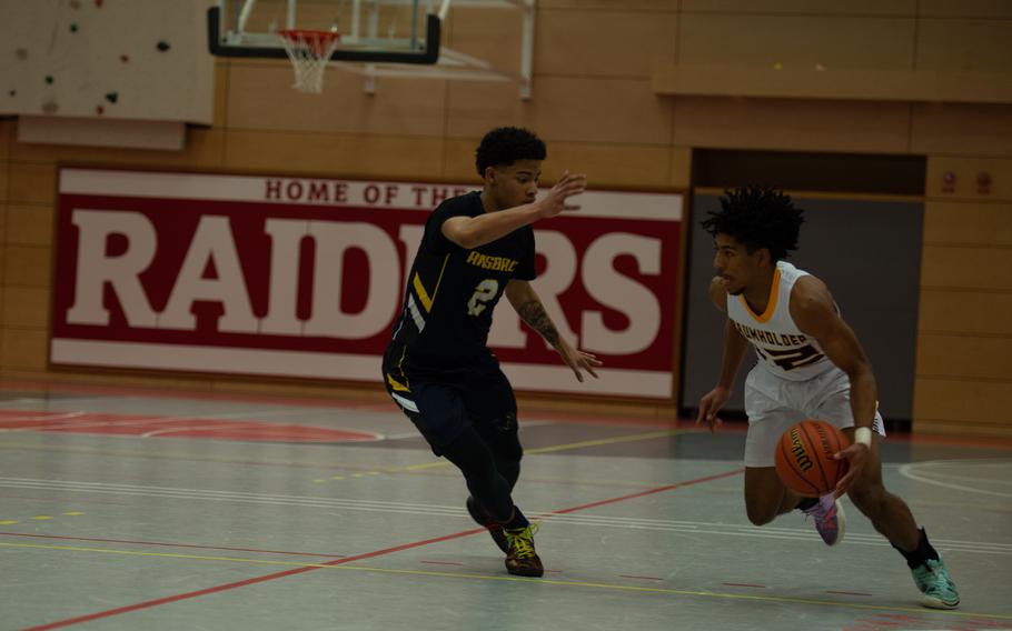 Ansbach's Shane Nesbitt tries to block the advance of Baumholder Buccaneer Jovan Velasquez during the DODEA-Europe Division III boys basketball title game in Kaiserslautern, Germany, on Saturday, Feb. 26, 2022.