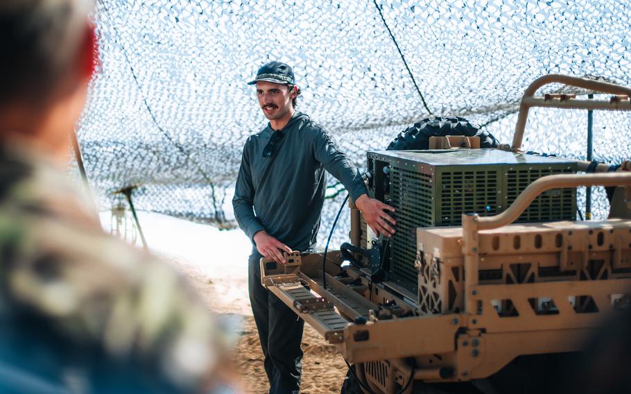 A representative of U.S. Indo-Pacific Command Logistics Science and Technology briefs visitors on the Atmospheric Portable-water Sustainment Unit and Lightweight Water Purification System at Marine Corps Base Hawaii, Sept. 30, 2022.  