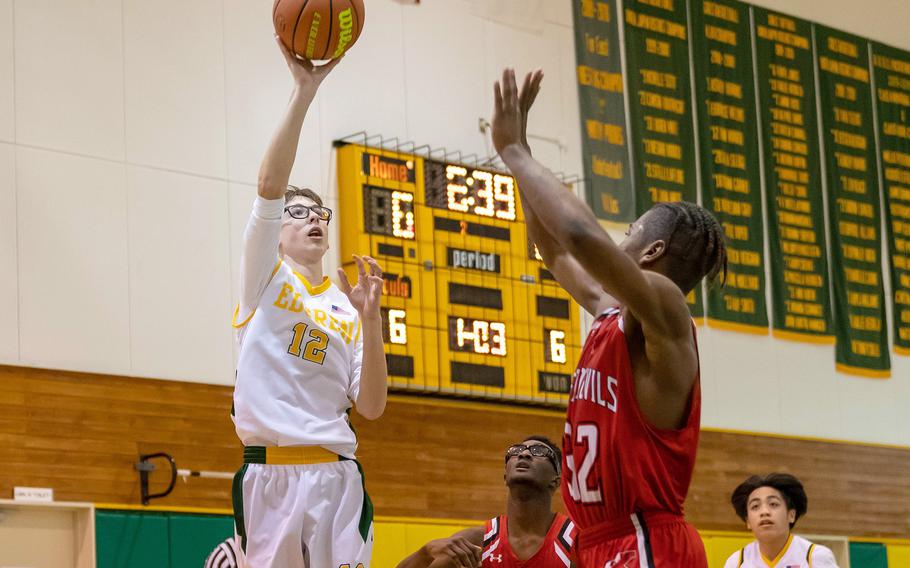 Robert D. Edgren's Josh Simmons shoots over Nile C. Kinnick's Nicholas Whyte during Friday's DODEA-Japan boys basketball game. The Red Devils won 65-31.