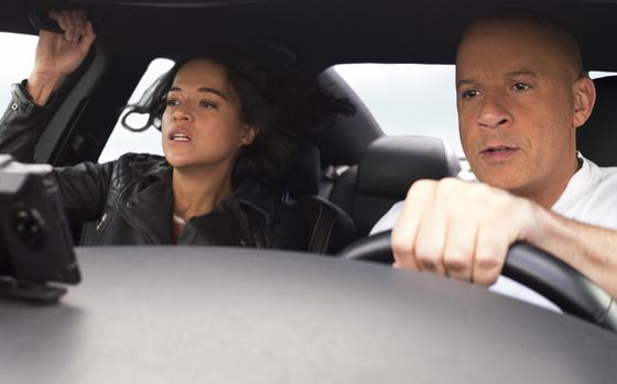 Michelle Rodriguez, left, and Vin Diesel are two of the many action stars in “F9: The Fast Saga.”