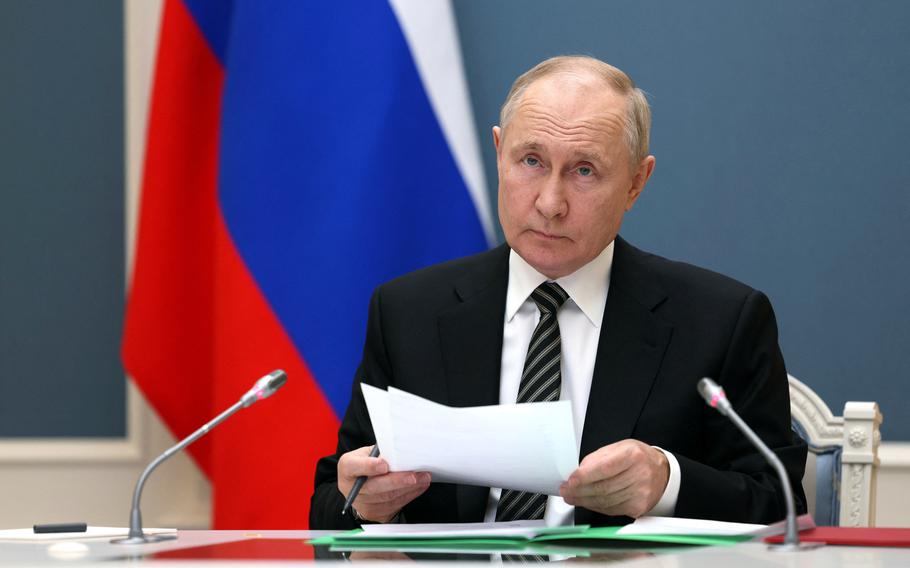 Russia’s President Vladimir Putin inspects a military exercise — which tests the country’s ability to deliver a massive retaliatory nuclear strike by land, sea and air — via a video link from Moscow, Oct. 25, 2023. 