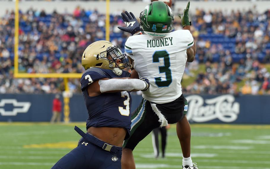 Navy defensive back Cameron Kinley, left, cannot prevent a 22-yard touchdown pass to Tulane wide receiver Darnell Mooney in the second quarter at Navy-Marine Corps Memorial Stadium in Annapolis, Md. The host Midshipmen won, 41-38.