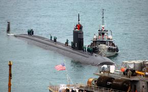 (1) 030221-N-0780F-020
(2) Souda Bay, Crete, Greece (Feb. 21, 2003) -- Nuclear-powered submarine USS San Juan (SSN 751) arrives for a port visit and prepares to be berthed outboard of submarine tender USS Emory S. Land (AS 39)
(3) San Juan is homeported in Groton, CT 
(4) U.S. Navy photo by Paul Farley