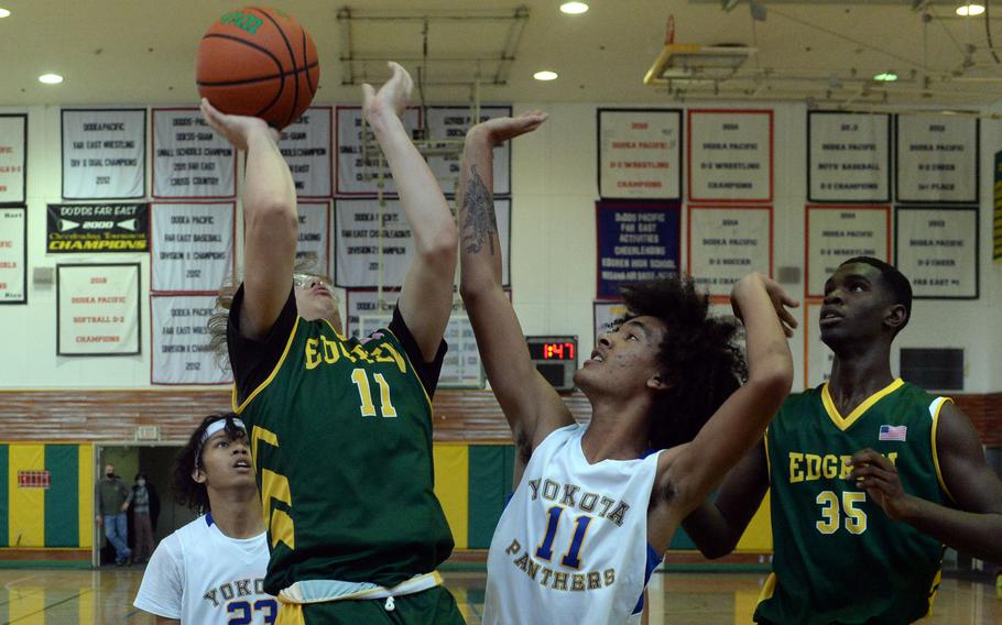 Robert D. Edgren's Rylend Meininger goes up for a shot against Yokota's Damian Abrams during Saturday's DODEA-Japan basketball game. The Panthers won 68-53.