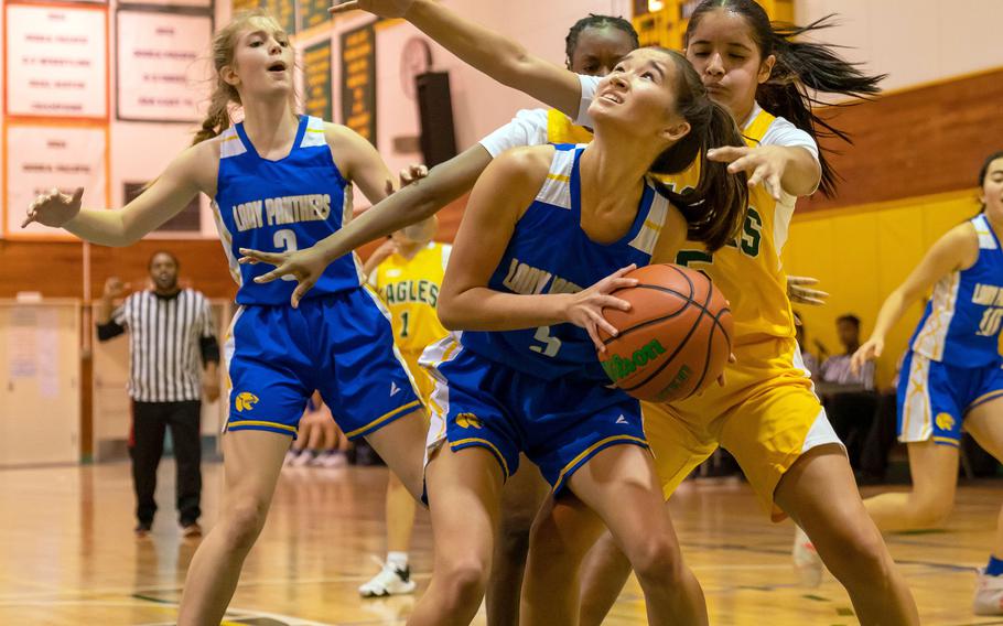 Yokota's Erica Haas tries to shoot against Robert D. Edgren's I'Lei Washington during Friday's DODEA-Japan girls basketball game. The Eagles edged the Panthers 20-19.