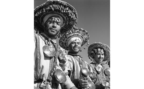 Marrakesh, Morocco, February, 1960:  Among the prime photographic targets for tourists visiting colorful Marrakesh were these water sellers with tasseled hats, kilt-like garb and strings of brass cups. They were happy to pose — for about $2 in local currency -- for Stars and Stripes photographer Gus Schuettler back in 1960.

Wondering where to travel off to this Spring and Summer? Check out the travel sections of Stars and Stripes' community sites!
https://ww2.stripes.com/communities

META TAGS: Travel; Europe; Japan; Okinawa; Guam; tourism; military family