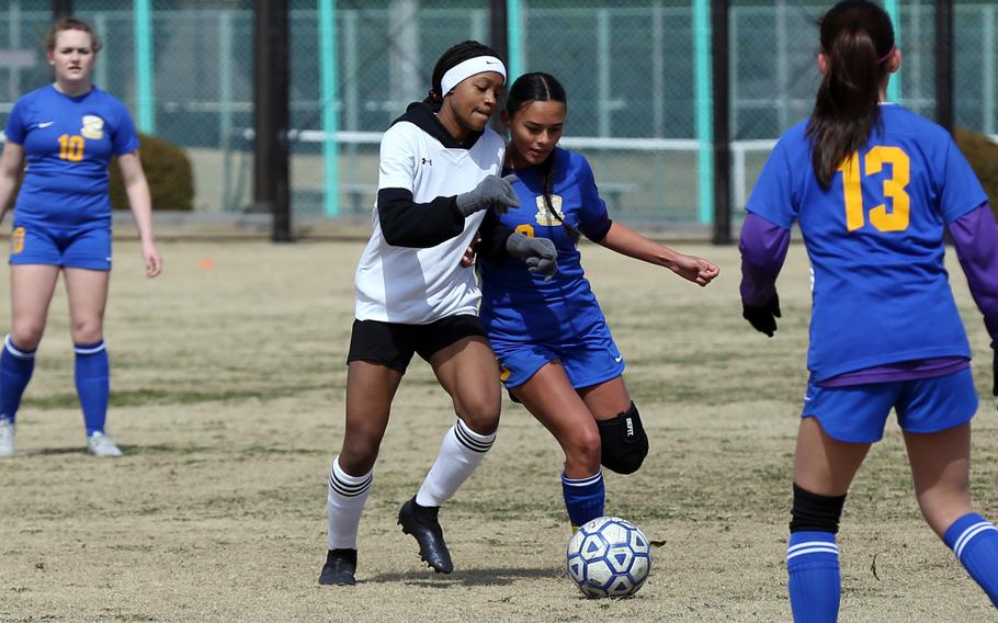 Robert D. Edgren's Nadiah Miller and Yokota's Mariah Hilliard battle for the ball during Saturday's DODEA-Japan girls soccer match. The Panthers won 8-0.