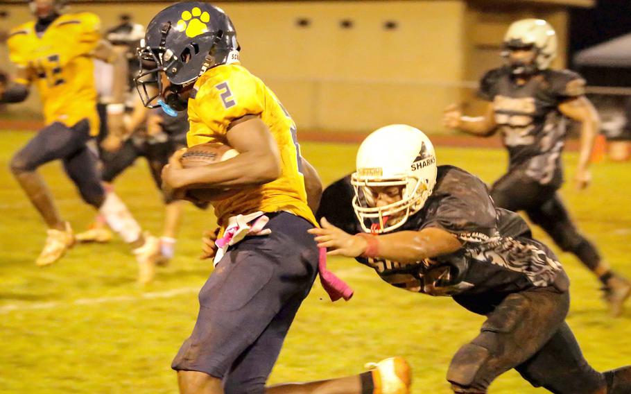 Guam High's Benjamin Harris races for the end zone ahead of Alika Farell of Simon Sanchez.