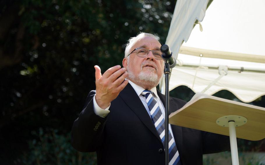 A rabbi speaks during a memorial service.