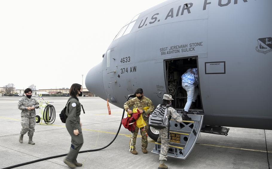 Yokota High School students board a C-130J Super Hercules at Yokota Air Base, Japan, Tuesday, March 8, 2022.