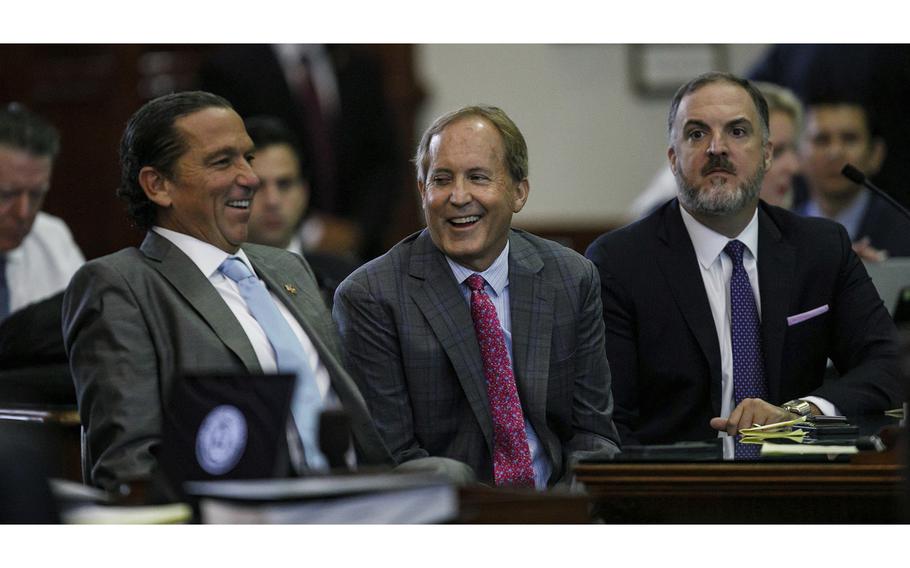 Texas Attorney General Ken Paxton, center, sits between defense attorneys Tony Buzbee, left, and Mitch Little, right, before his impeachment trial resumes in the Senate Chamber at the Texas Capitol on Friday, Sept. 15, 2023, in Austin, Texas. 