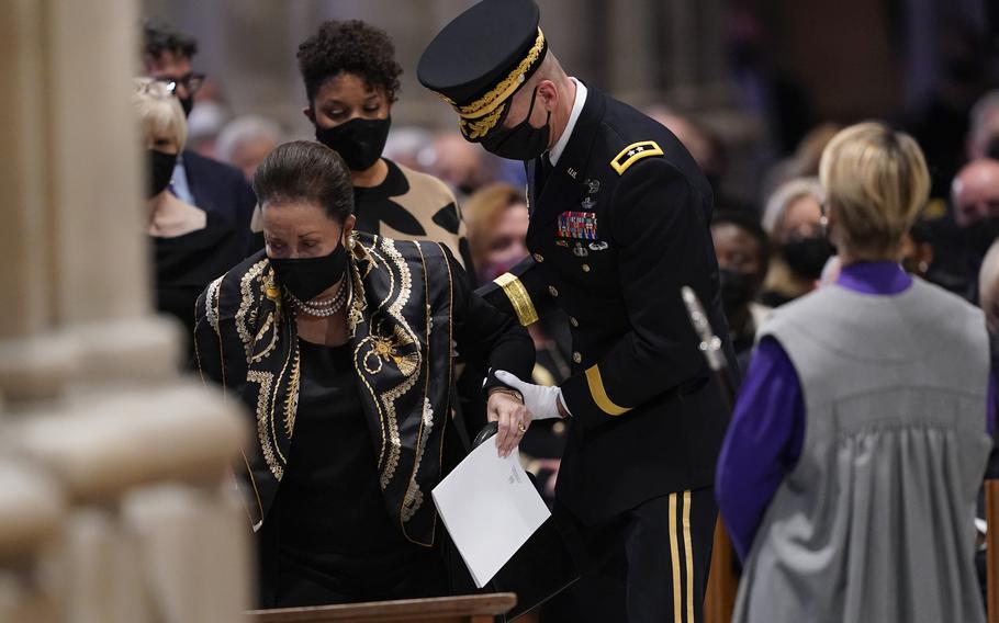 Alma Powell, is escorted to her seat by U.S. Army Major Gen. Allan Pepin, commanding officer of the Joint Force Headquarters National Capitol Region, before the funeral for former Secretary of State Colin Powell at the Washington National Cathedral, in Washington, Friday, Nov. 5, 2021. 