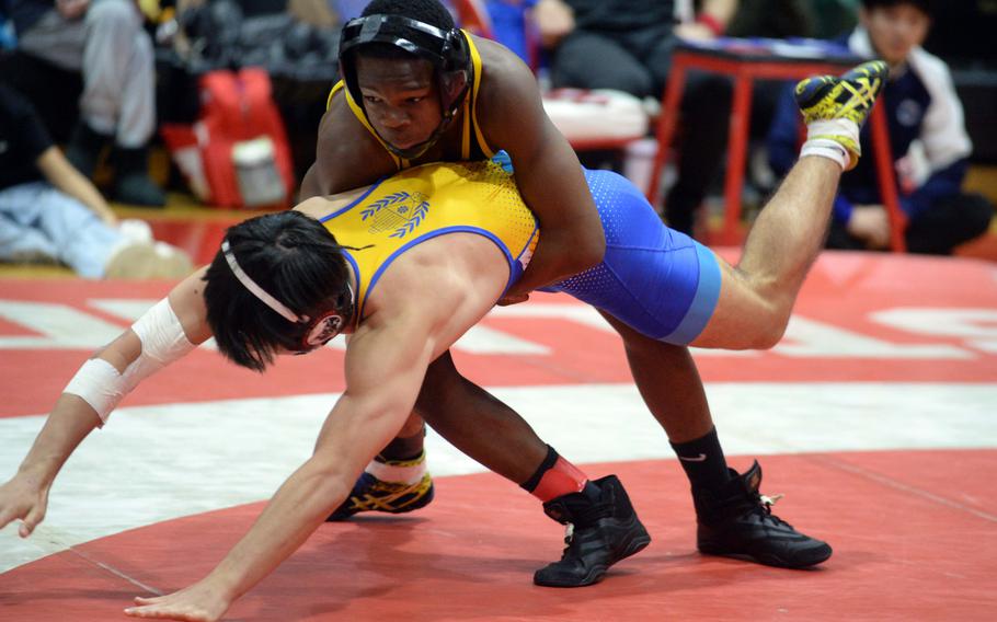 American School In Japan 133-pounder Cadell Lee, a former Virginia state champion, takes control of St. Mary’s Nathaniel Twohig en route to an 11-0 technical-fall victory in the final.