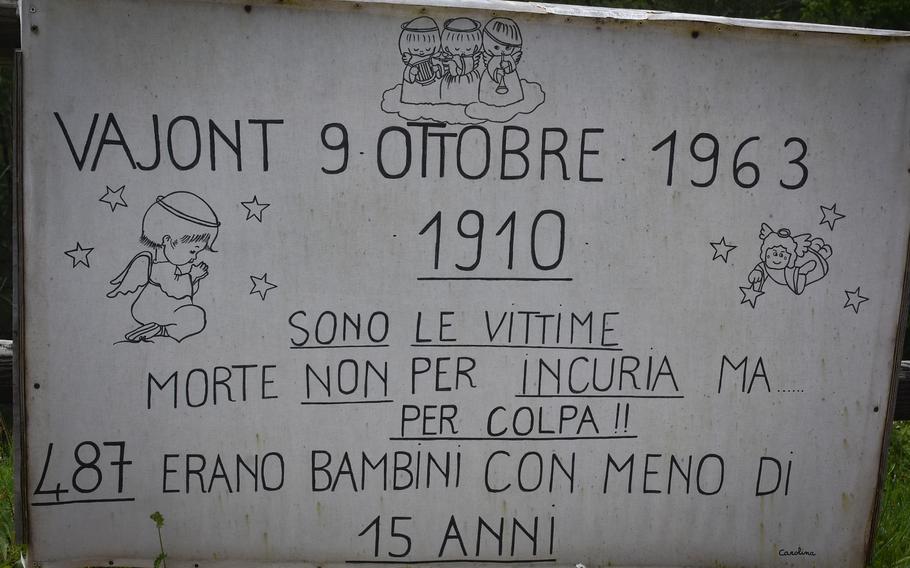 A memorial sign above the Vajont Dam in Italy commemorates the 1,910 people who died Oct. 9, 1963, when a wave of water swept over the dam and destroyed several villages beneath it. The sign says 487 of the victims were children age 15 and under.