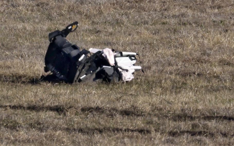 An F-35B military aircraft pilot seat rests off the runway at the Naval Air Station Joint Reserve Base in Fort Worth, Dec. 15, 2022. The pilot ejected successfully as the plane bounced off the runway and crashed after hovering.