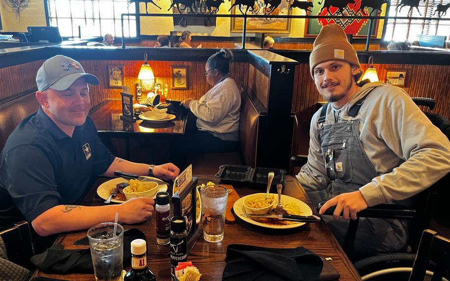 Army Sgt. 1st Class Corey Engard meets with Colton Rogers, 22, at a steakhouse, Jan. 19, 2024. The two have bonded in the wake of a crash in east-central Mississippi on Nov. 17, 2023. Engard saved the life of a badly bleeding Rogers.