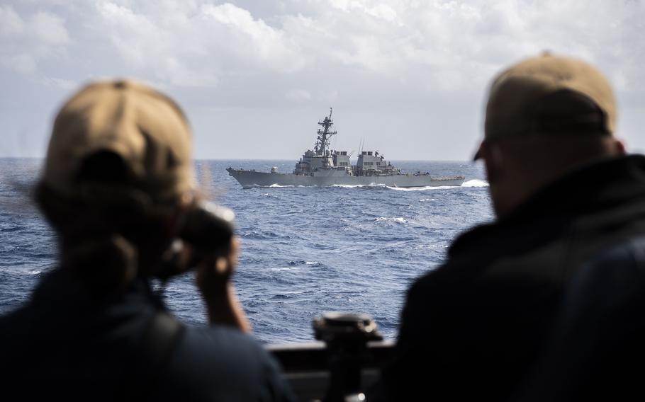 The guided-missile destroyer USS Benfold, photographed from the destroyer USS Dewey, trains in the South China Sea, Jan. 12, 2022. 
