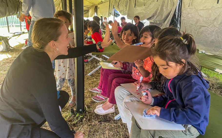 Morgan Guinn, a teacher at Kaiserslautern Middle School, gives an English lesson to Afghan children at Rhine Ordnance Barracks, Germany.