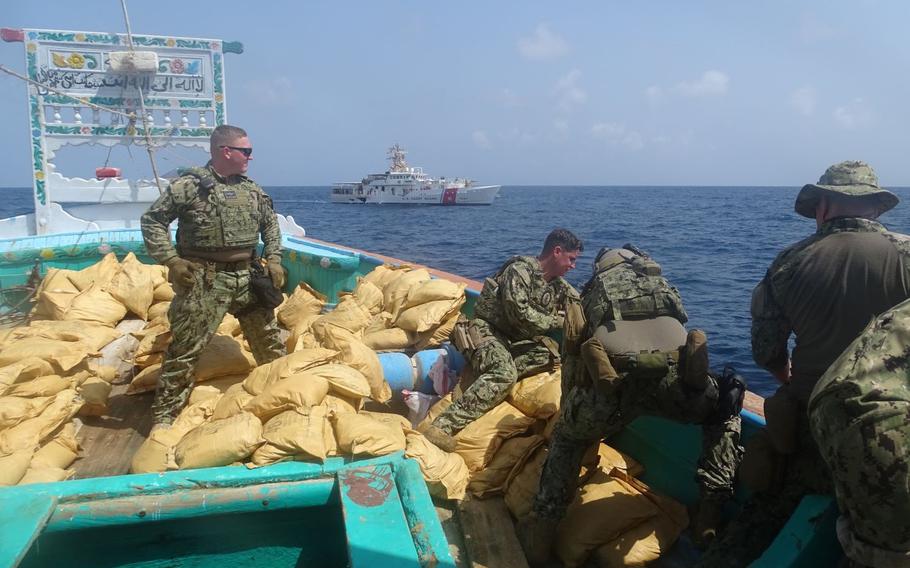U.S. Coast Guard personnel seize bags of illegal drugs from a fishing vessel interdicted by fast response cutter USCGC Charles Moulthrope in the Gulf of Oman on Sept. 27, 2022.