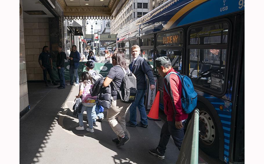 Migrants arrive at the Roosevelt Hotel in Midtown Manhattan on Friday, May 19, 2023, in New York City. 