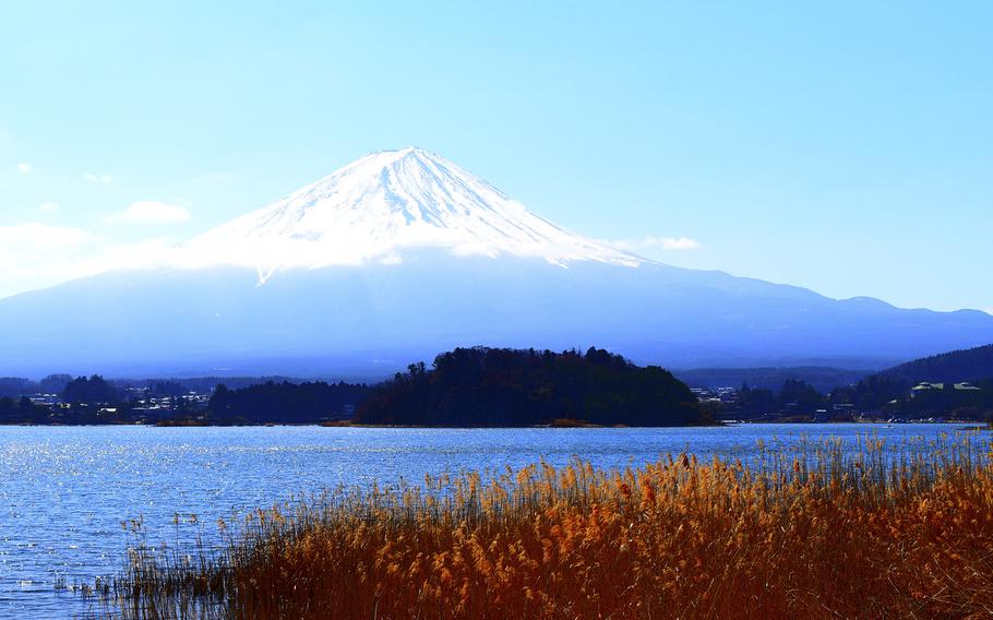 A snow-capped view of Mount Fuji from the banks of Lake Kawaguchiko in Yamanshi prefecture, Japan.