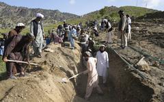 Afghans dig a trench for a common grave for their relatives killed in an earthquake to a buria site l in Gayan village, in Paktika province, Afghanistan, Thursday, June 23, 2022. A powerful earthquake struck a rugged, mountainous region of eastern Afghanistan early Wednesday, flattening stone and mud-brick homes in the country's deadliest quake in two decades, the state-run news agency reported. (AP Photo/Ebrahim Nooroozi)
