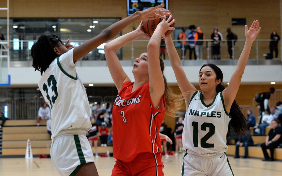 AOSR’s Nina Neroni shoots between Naples’ Darcel Shine, left, and Anais Navidad in the girls Division II final at the DODEA-Europe basketball championships in Wiesbaden, Germany, Feb. 17, 2024. Naples beat AOSR 48-29 for the title.