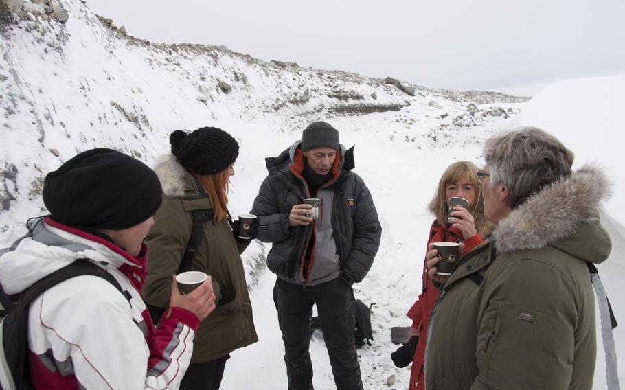 A group of Danish hikers stop near the Greenlandic ice sheet to grab some “blueberry soup” and an energy bar. The ice sheet covers more than 80 percent of Greenland, and rises to 2 miles thick at its peak.