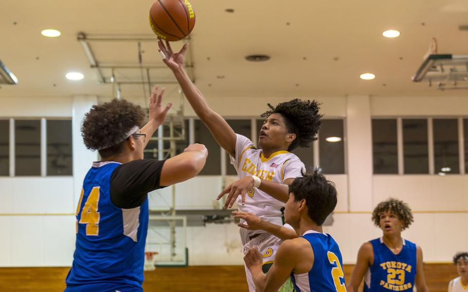 Robert D. Edgren's Dominique Waters skies over three Yokota defenders to shoot during Friday's DODEA-Japan boys basketball game. The Panthers won 67-57.