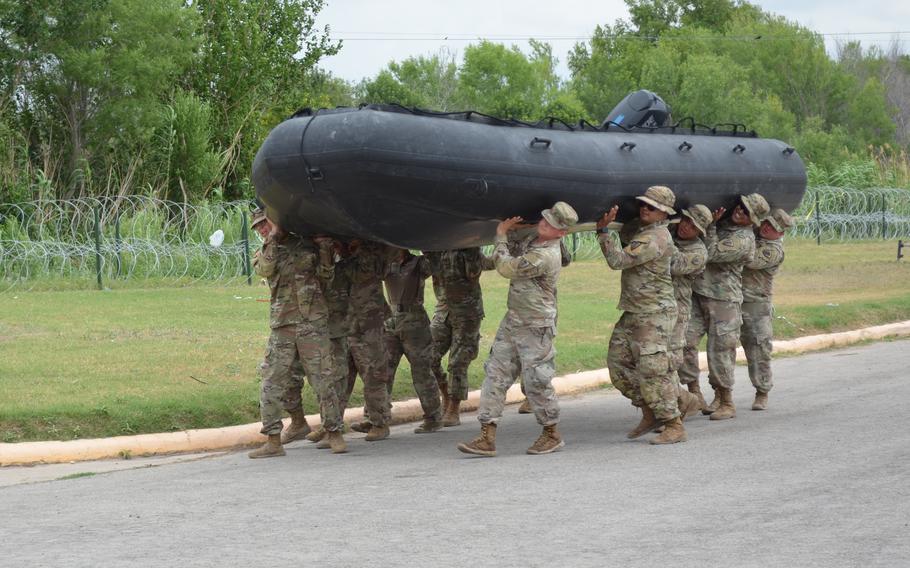 Texas National Guard troops prepare an inflatable boat to launch into the Rio Grande from a park in Eagle Pass, Texas, on May 23, 2022. The Guard spent $293,000 on boats and equipment in April to begin increasing patrols on the water as part of a state-sponsored border security mission known as Operation Lone Star. 