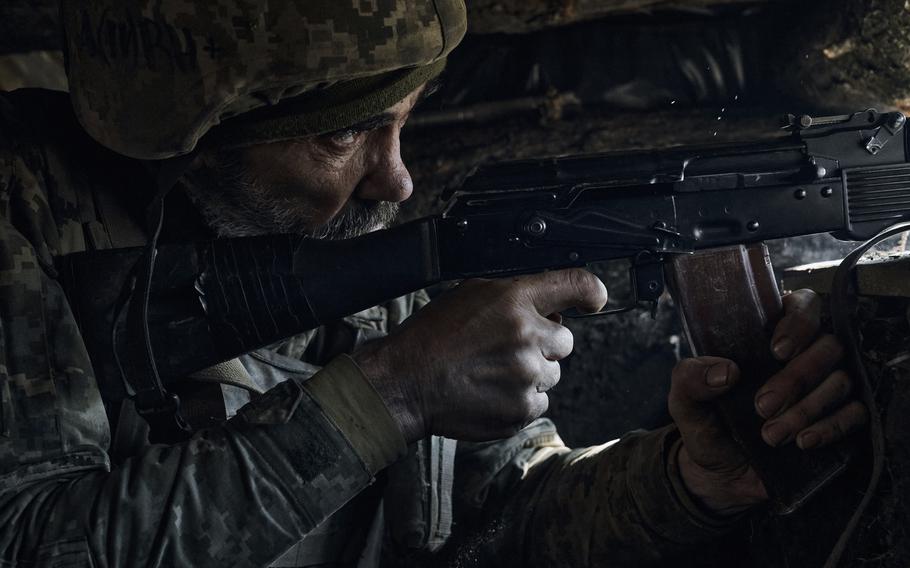 A Ukrainian soldier of the 28th brigade fires on the frontline during a battle with Russian troops at the frontline near Bakhmut, Donetsk region, Ukraine, Friday, March 24, 2023. 