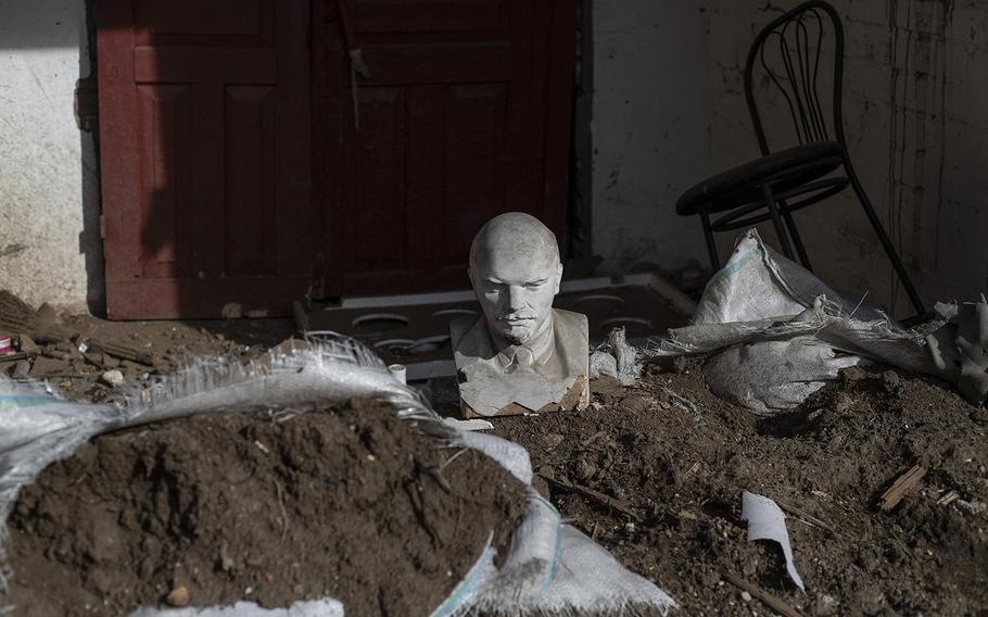 A small bust of Vladimir Lenin rests on the ground outside a school used as a headquarters for the Russian military when it occupied the village of Khreshchenivka in the Kherson region. The village was liberated by Ukrainian forces. 
