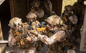 Latvian special operations forces climb and clear a flight of stairs in a simulated urban environment during an exercise  on Camp Grayling, Michigan, in 2023. Latvia is, behind Poland and Lithuania, the third largest defense spender in NATO on a per capita basis, according to the alliance.

