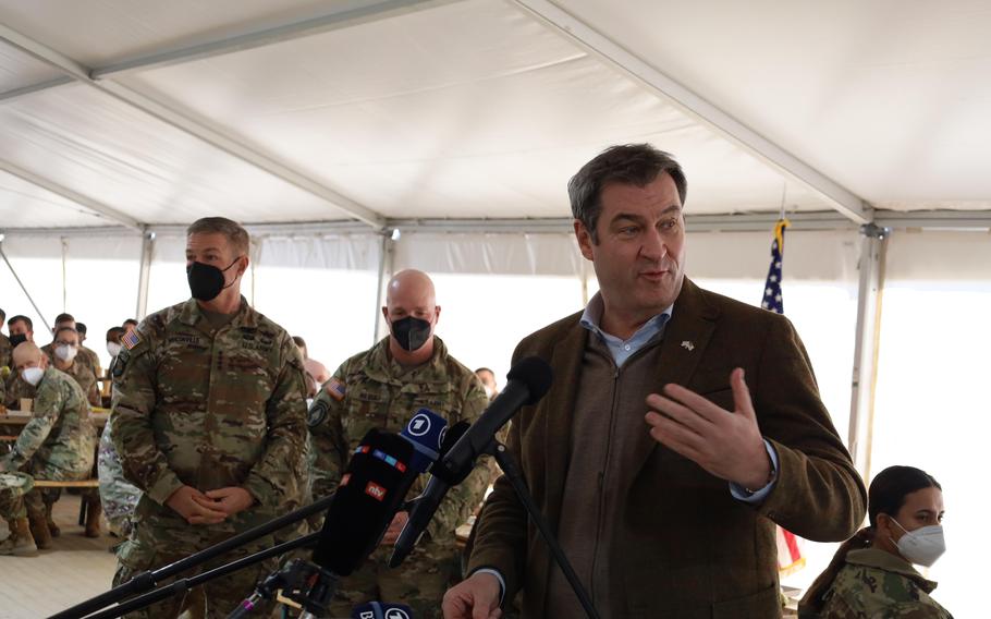 Bavarian governor Markus Soeder speaks to soldiers waiting for their weisswurst and pretzel breakfast at Grafenwoehr Training Area, on March 11, 2022. Weisswurst, or white sausage, is a specialty of Bavaria.