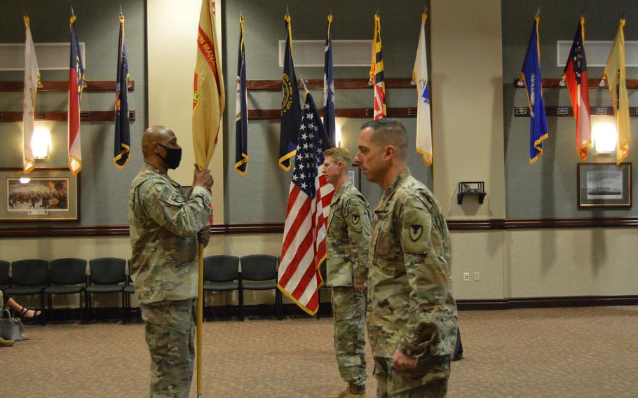 Col. Nathan R. Springer, right, incoming commander, U.S. Army Garrison Fort Carson, “accepts” the garrison colors from Command Sgt. Maj. Kenyatta L. Mack, left, senior enlisted leader, and Col. Brian K. Wortinger, center, outgoing commander, during a change of command ceremony at 4th Infantry Division Headquarters July 8, 2020. Springer will leave the post as Fort Carson’s chief commander on July 19.
