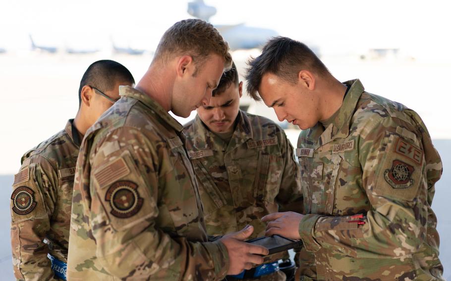 Maintainers review technical orders at Travis Air Force Base, Calif., on Oct. 14, 2022. A new Air Force program will allow airmen to review orders and mutually agree to swap assignments.