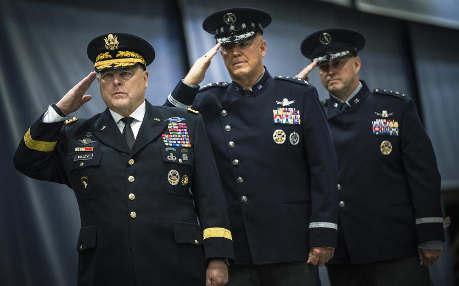 Army Gen. Mark Milley, chairman of the Joint Chiefs of Staff, Gen. John Raymond, Space Force chief of space operations, and Gen. Chance Saltzman, incoming Space Force chief of space operations, salute Wednesday, Nov. 1, 2022, during the playing of the National Anthem at Joint Base Andrews, Md. 